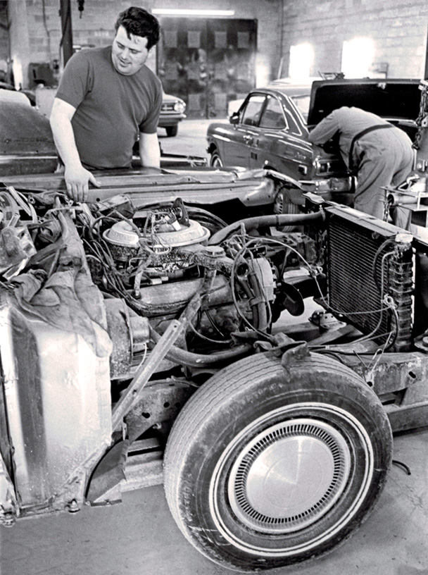 Vintage Shot of Body Shop Repairing Car